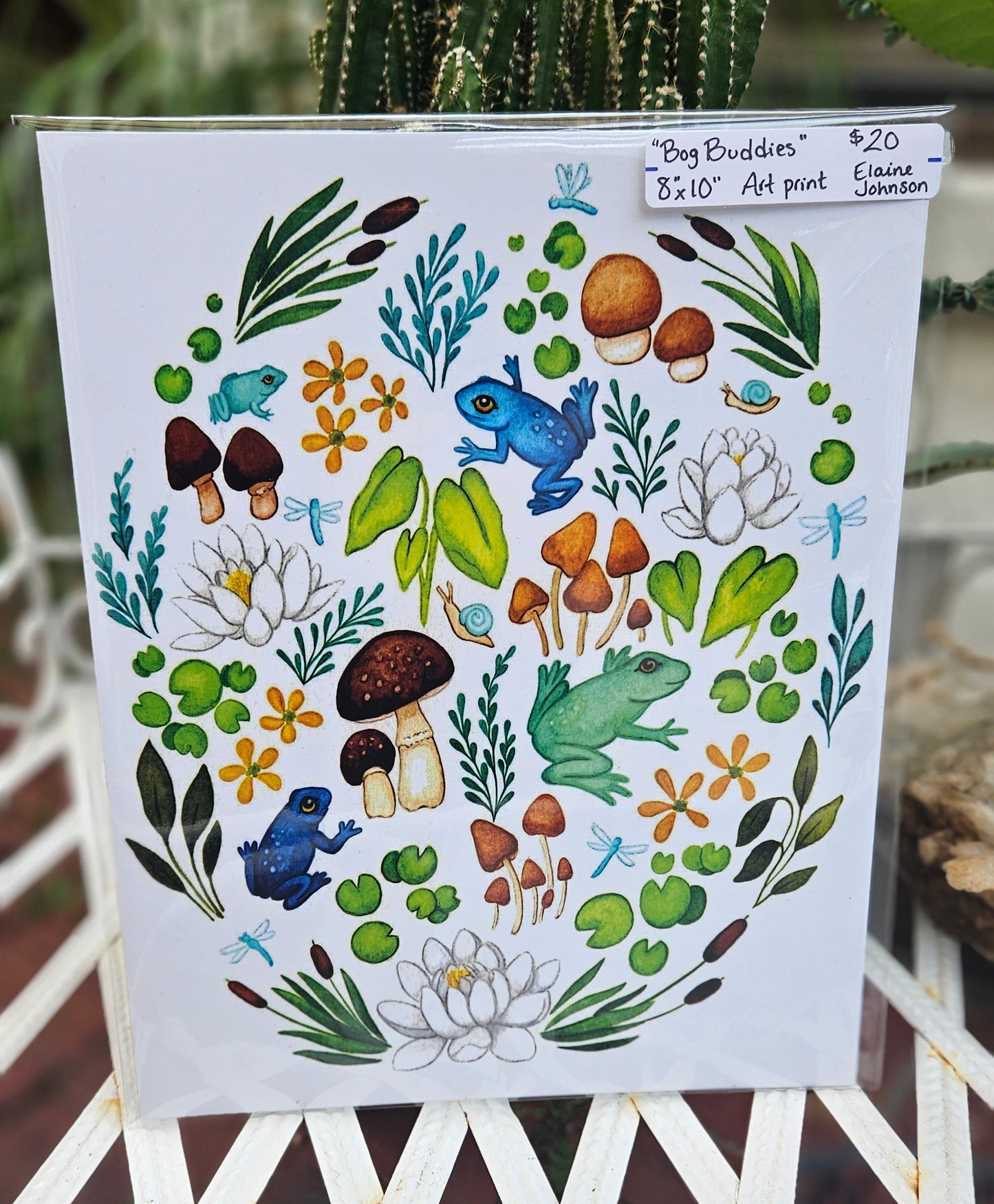Decorative paper with nature-themed design featuring frogs, plants, and flowers on a white background.