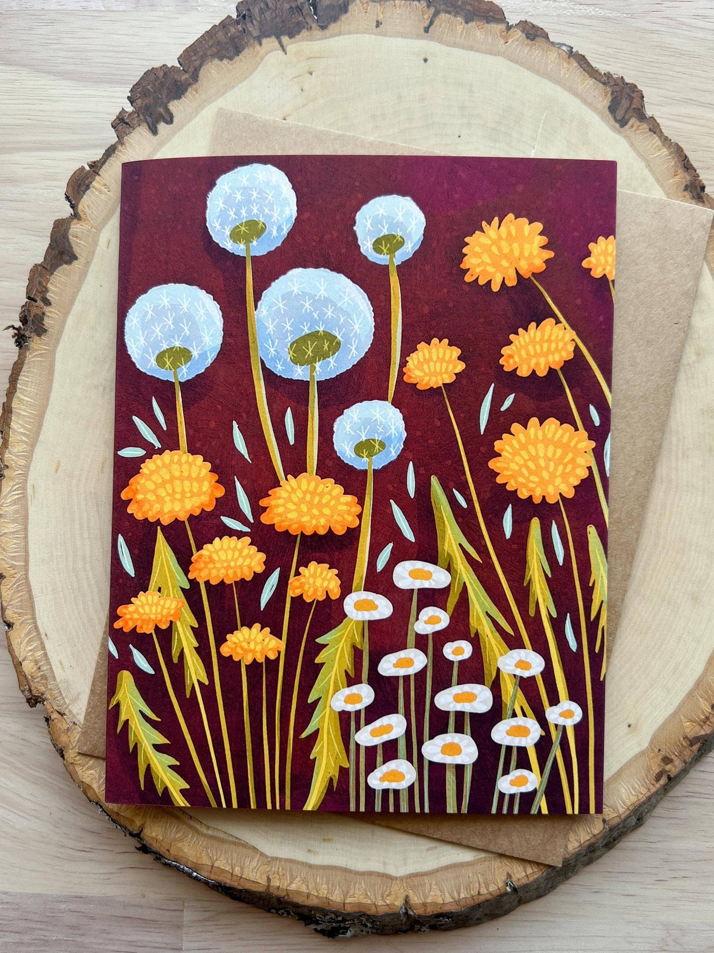 Card with floral design on a wooden surface
