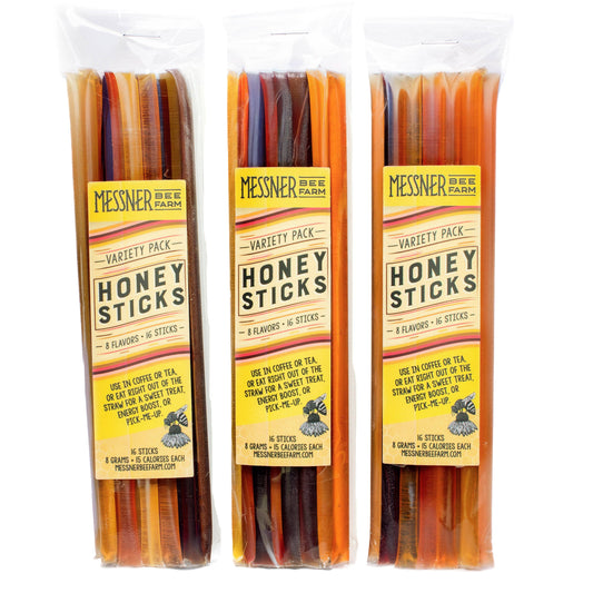 Three packages of Messner Bee Farm honey sticks on a white background