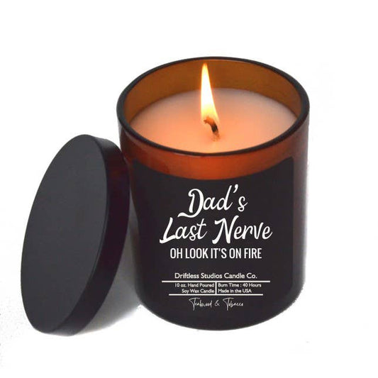 Candle in a black container with 'Dad's Last Nerve' text on a white background