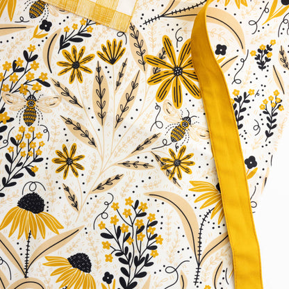 Fabric with yellow floral pattern and 'Gingiber' label on a white background