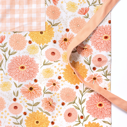 Floral-patterned mat with a person's hand holding it, featuring the brand 'Ginger.'