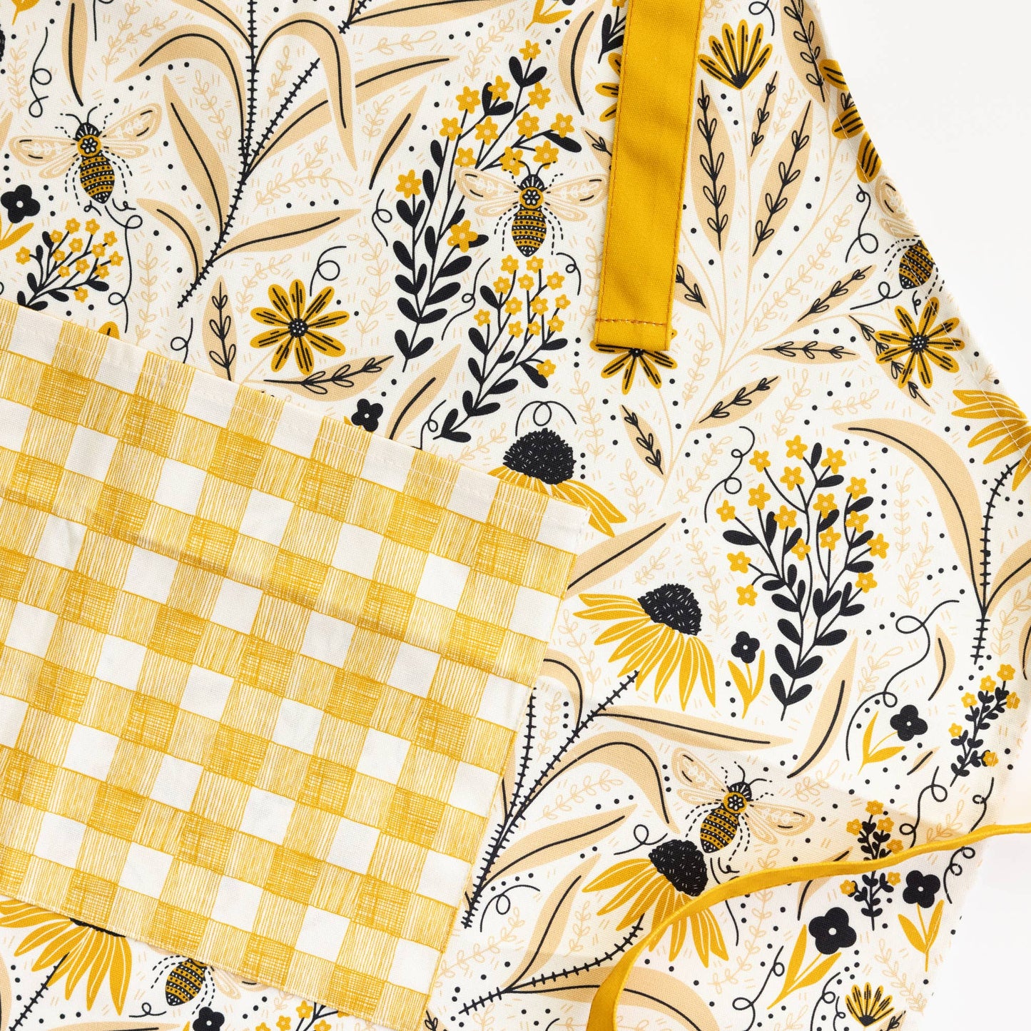 Floral and checkered patterned fabric with yellow and black accents
