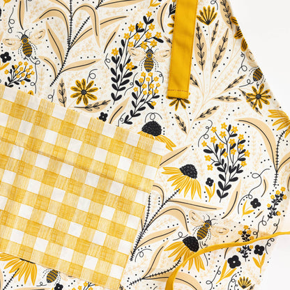 Floral and checkered patterned fabric with yellow and black accents