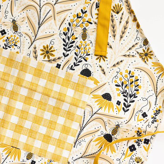 Floral and checkered patterned fabric with yellow and black accents