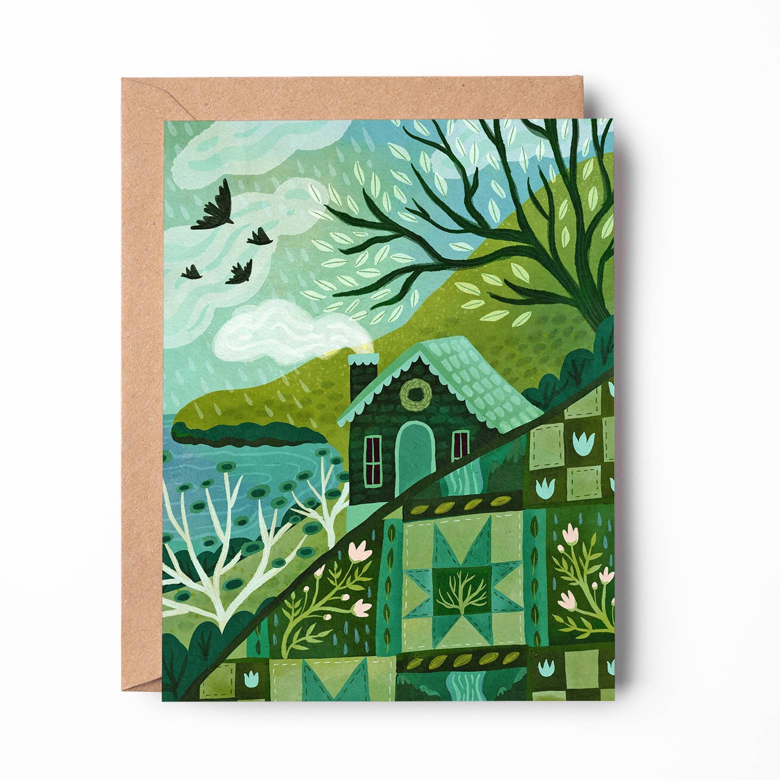 A square art print or card featuring a stylized landscape illustration in shades of green, teal, and brown, shown with a kraft paper envelope behind it on a white background.