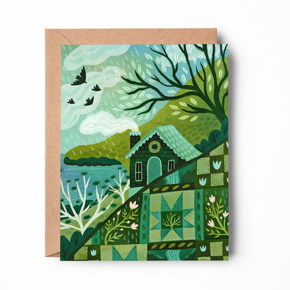 A square art print or card featuring a stylized landscape illustration in shades of green, teal, and brown, shown with a kraft paper envelope behind it on a white background.