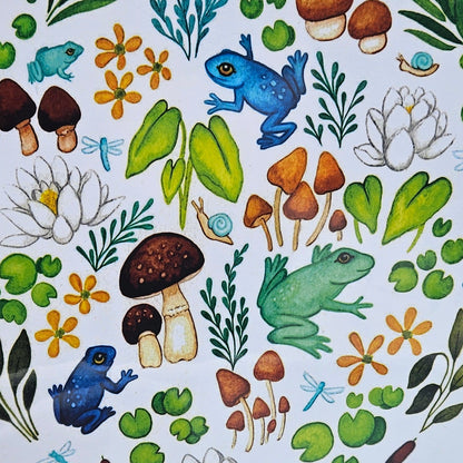 Decorative paper with nature-themed design featuring frogs, plants, and flowers on a white background.