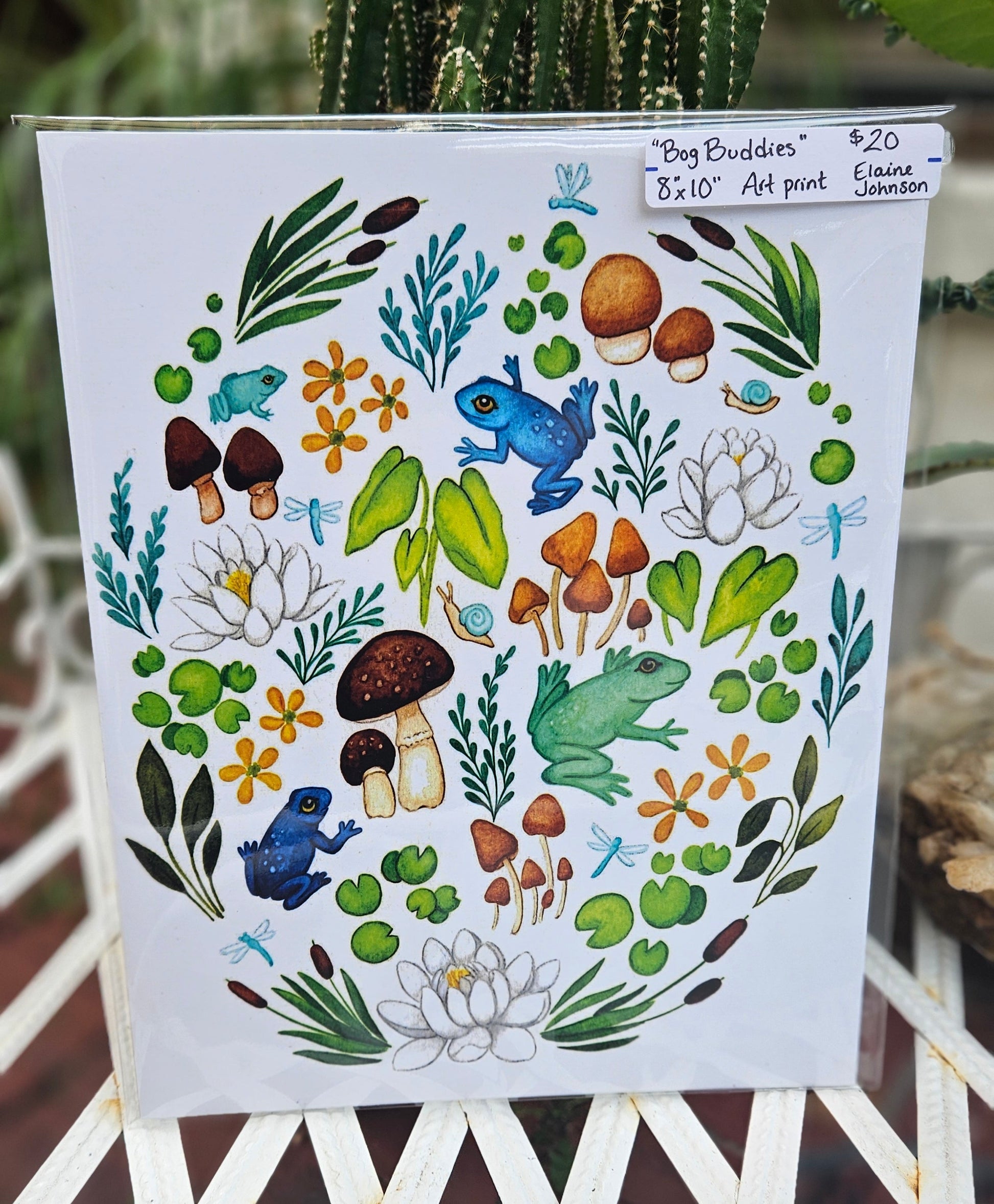 Decorative paper with nature-themed design featuring frogs, plants, and flowers on a white background.