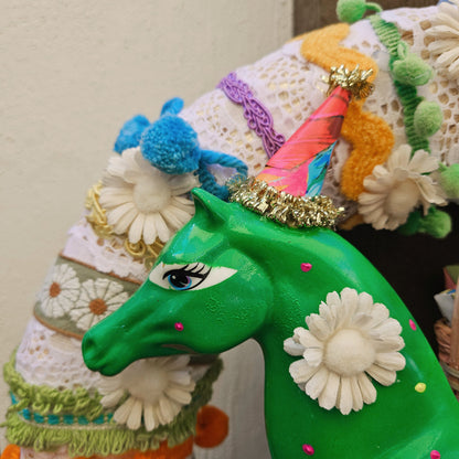 Colorful horse figurine with decorative elements on a plain background