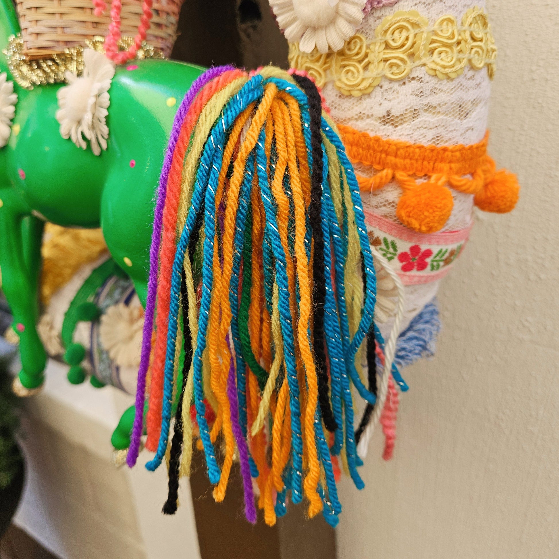 Colorful yarn horse tail on a neutral background