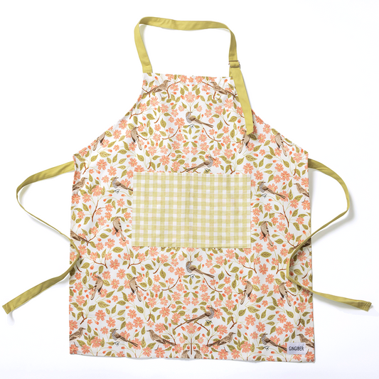 Floral-patterned apron with a checkered pocket on a white background