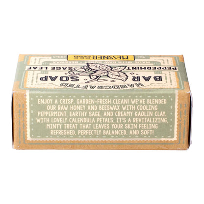 Handcrafted Bar Soap in a square kraft paper box with a vintage-style label. The label features a muted green top section and a tan/brown bottom section with cream-colored text describing the scent as a blend of peppermint, earthy sage, and creamy kaolin clay.