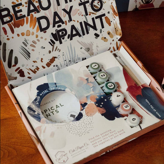 Painting kit with 'It's a Beautiful Day to Paint' text on the lid