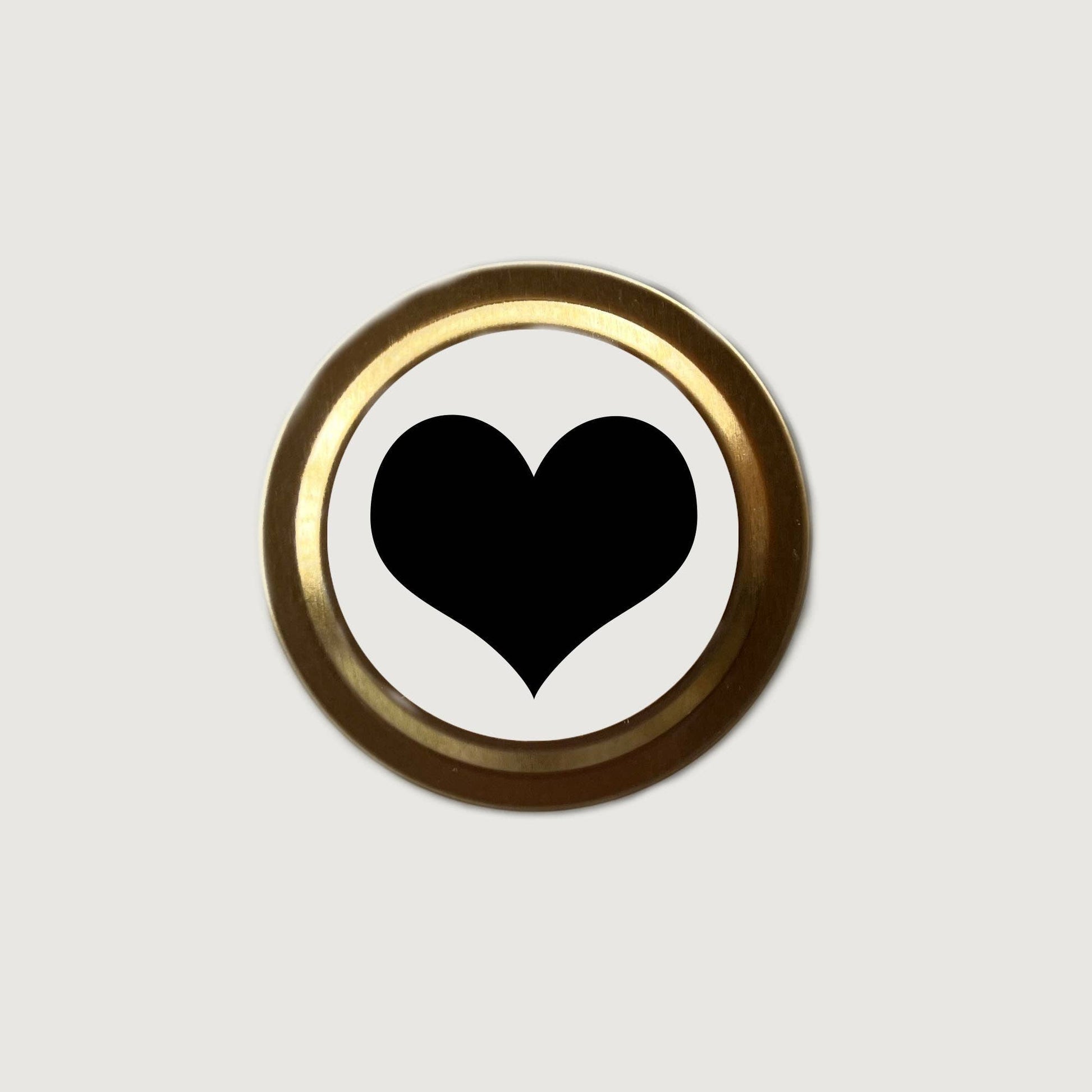 Black heart symbol on a white background with a gold border
