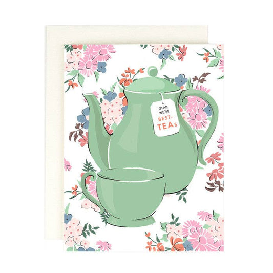 Card with a green teapot and floral design on a white background