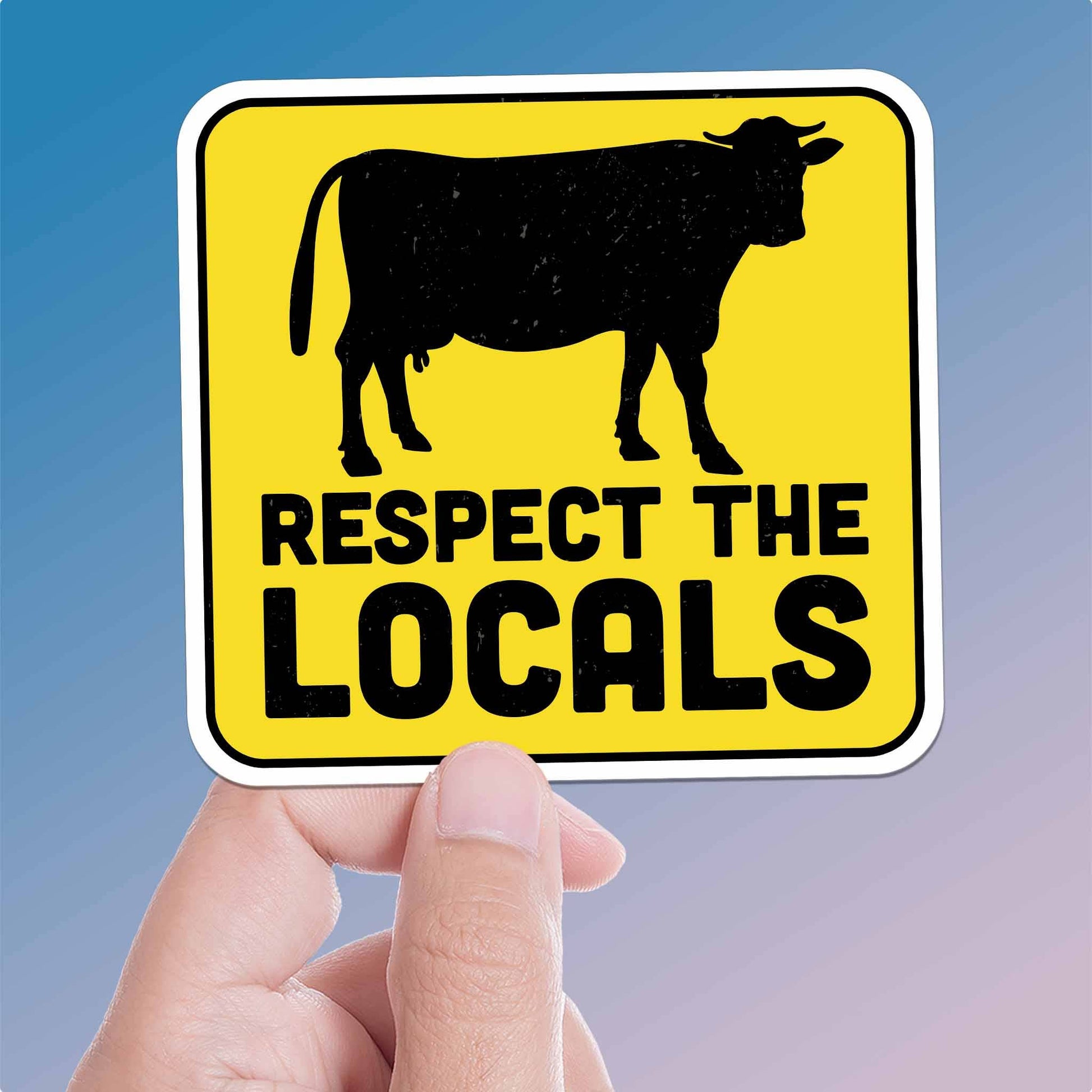 Hand holding a sign with a cow silhouette and 'Respect the Locals' text against a blue background