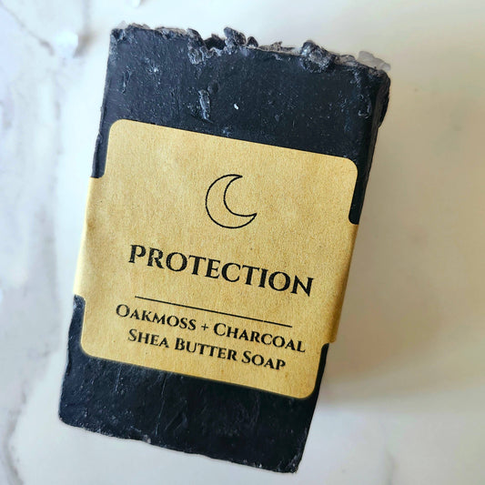 Black soap bar with a gold label on a white background