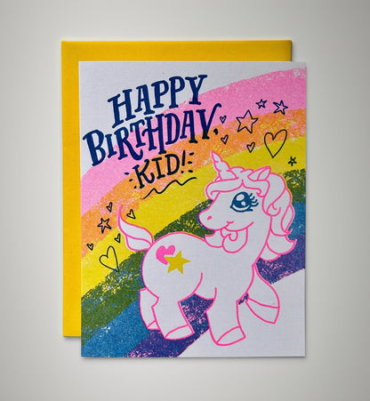 Birthday card with a unicorn illustration and colorful rainbow design.