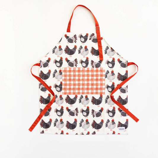 Children's apron with chicken pattern and red straps on a white background