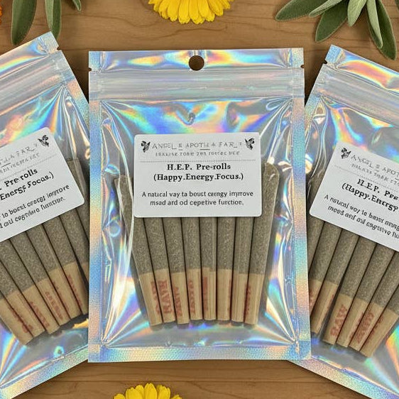 Three packages of pre-rolled joints with labels on a wooden surface surrounded by flowers and leaves.