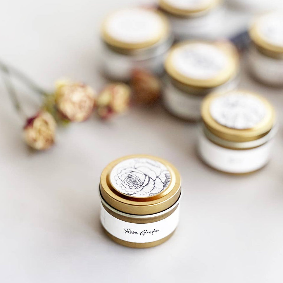 Small jars with gold lids on a light background
