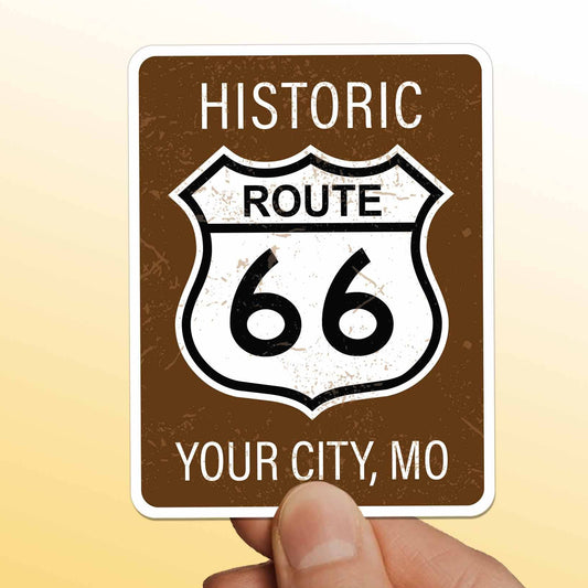 Hand holding a 'Historic Route 66' sign with customizable text on a yellow background