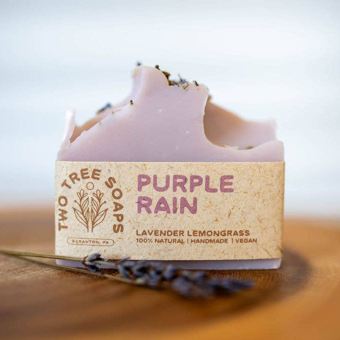 Bar of soap with 'Purple Rain' label on a wooden surface