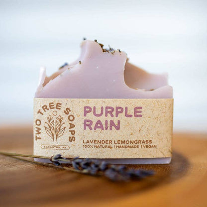 Bar of soap with 'Purple Rain' label on a wooden surface