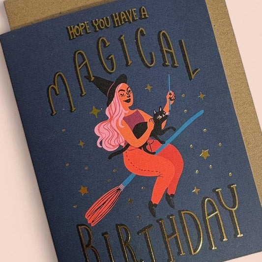 Greeting card with witch illustration and 'Magical Birthday' text on a beige background