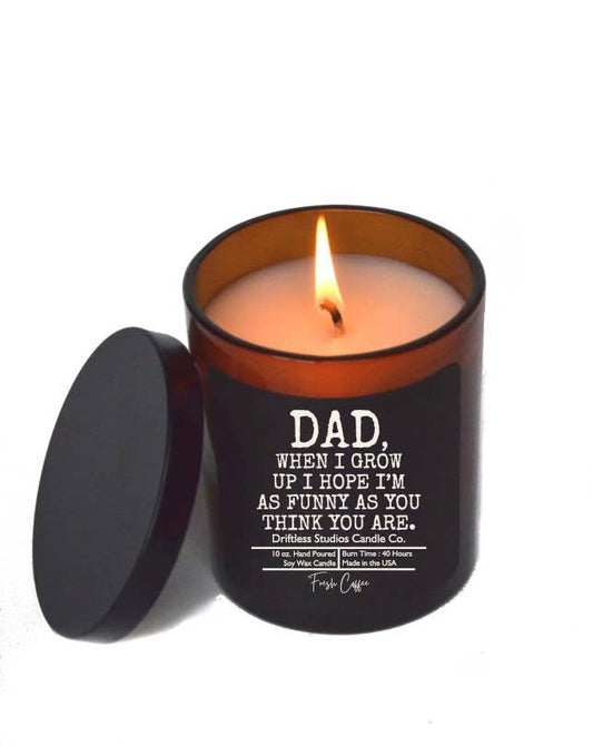 Candle in a black container with a humorous message on a white background