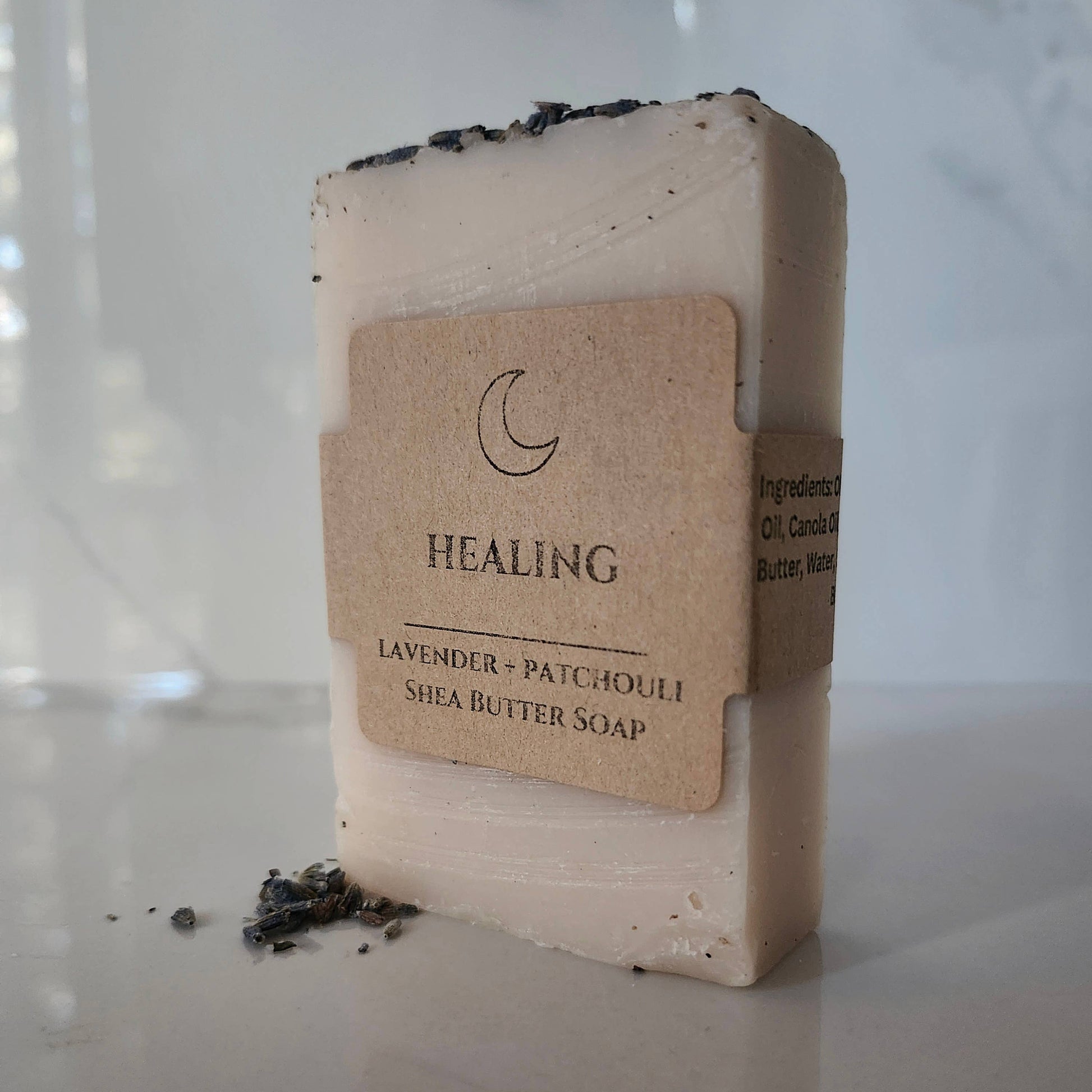 Shea butter soap bar with a label on a reflective surface