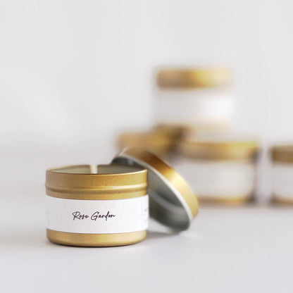 Candle with gold lid and white label on a light background