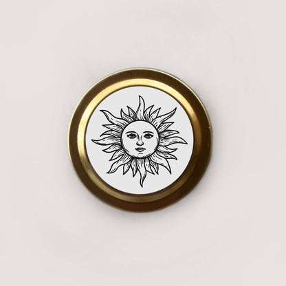 Round badge with sun design and gold border on a white background