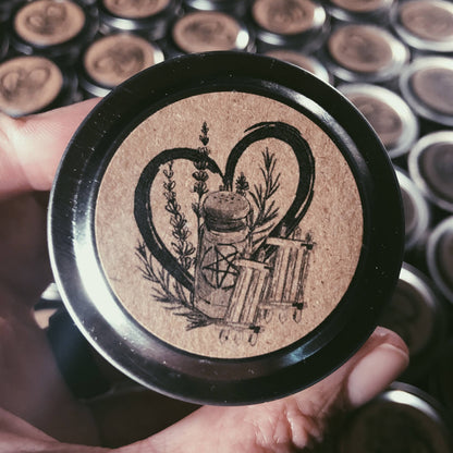 Close-up of a decorative button with intricate design held by a hand against a background of similar buttons.
