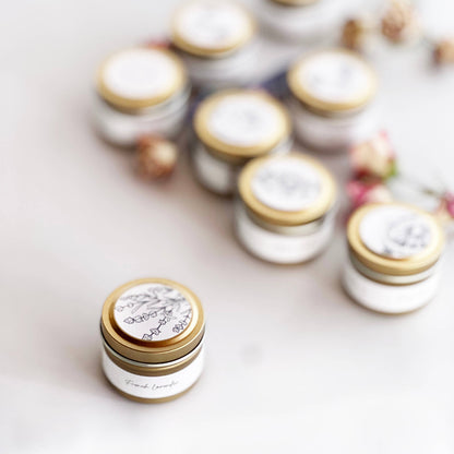 Small jars with gold lids on a light background