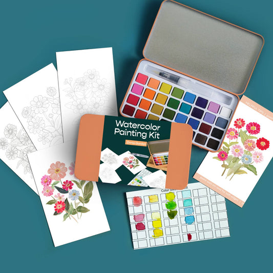 Watercolor painting kit with paint swatches, cards, and a tin on a teal background
