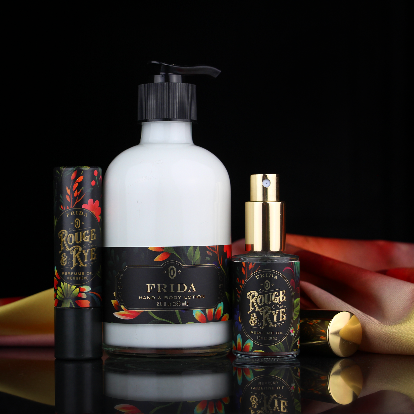 Three skincare products from Rouge & Rye and Frida on a reflective surface with a black background