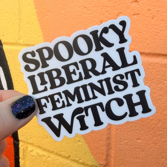 Sticker with text 'Spooky Liberal Feminist Witch' held against an orange background
