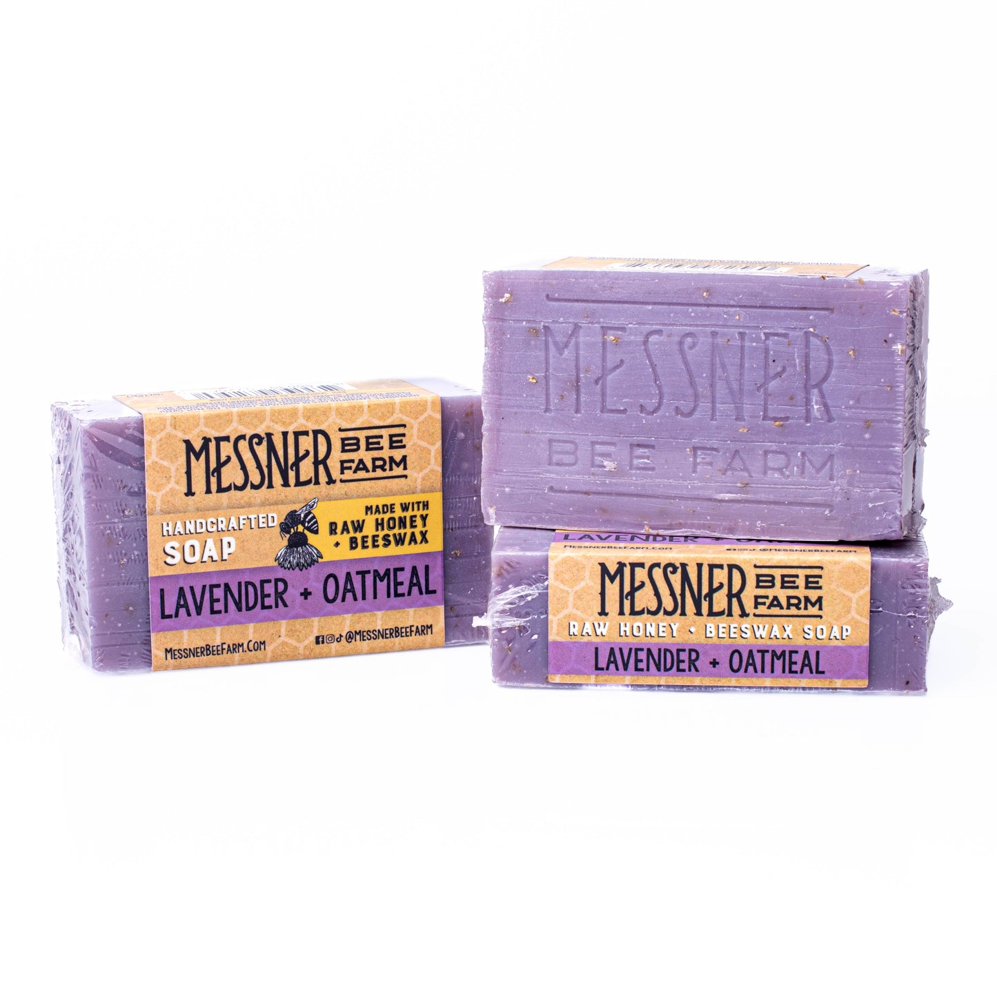 Two bars of Messner Bee Farm lavender and oatmeal soap on a white background