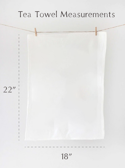 White tea towel hanging on a line with measurements indicated.