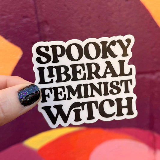 Sticker with text 'Spooky Liberal Feminist Witch' held over a colorful background