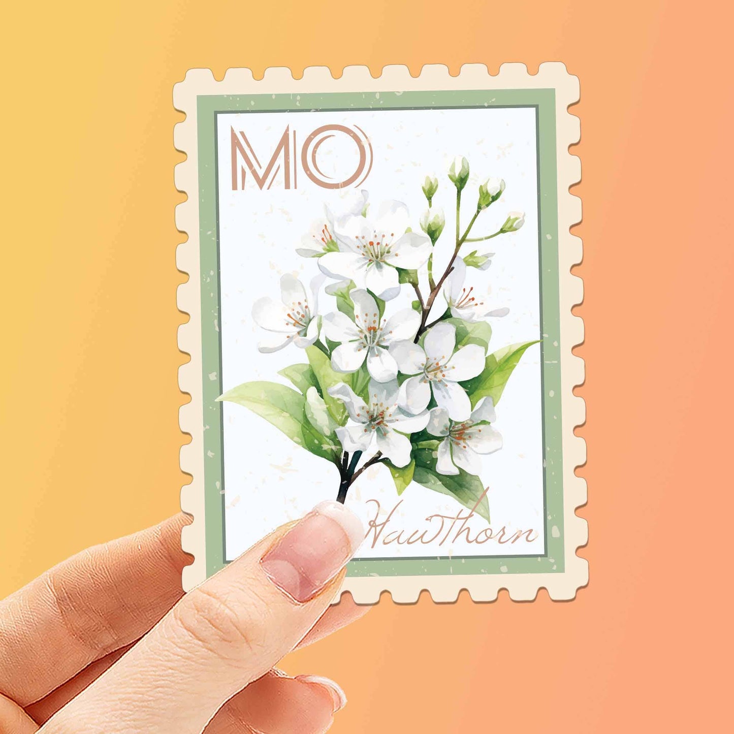 Hand holding a decorative card with a floral design and 'MO' initials on an orange background