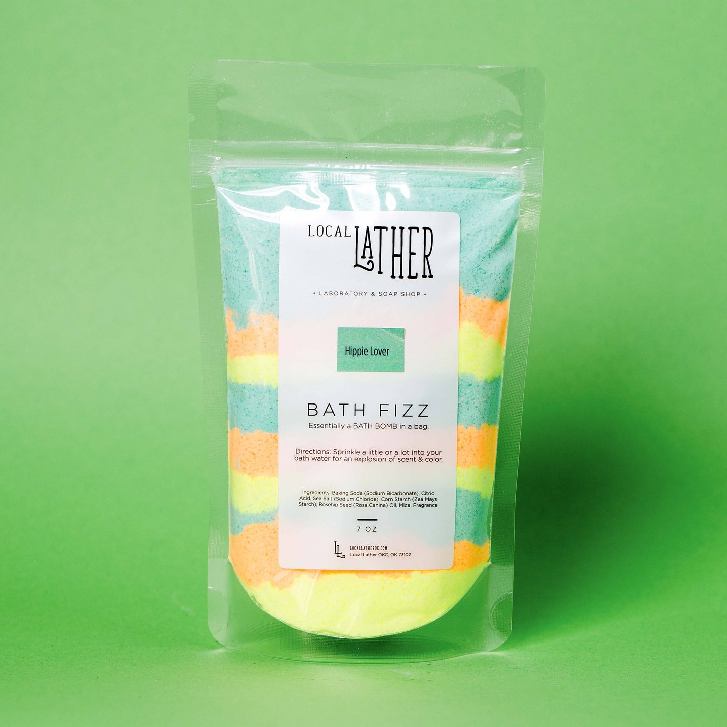 Packaged bath fizz with colorful design on a green background