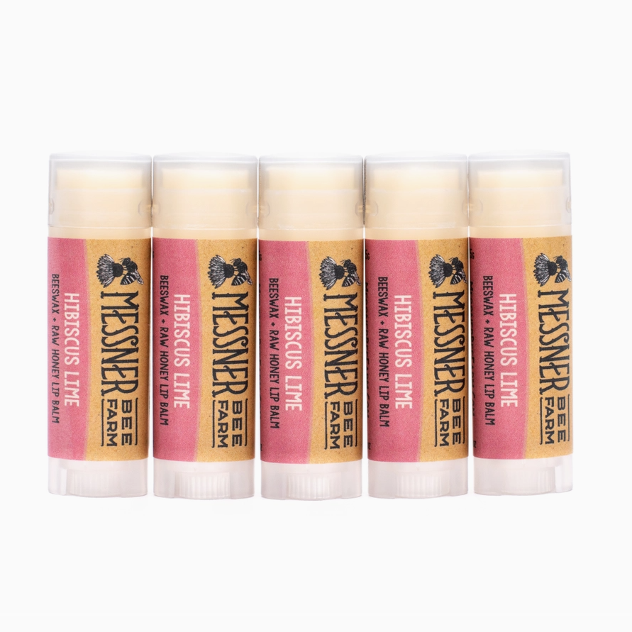Five lip balm sticks with visible branding on a white background