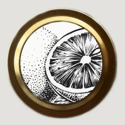 Canle lid with citrus illustration in black and white on white background