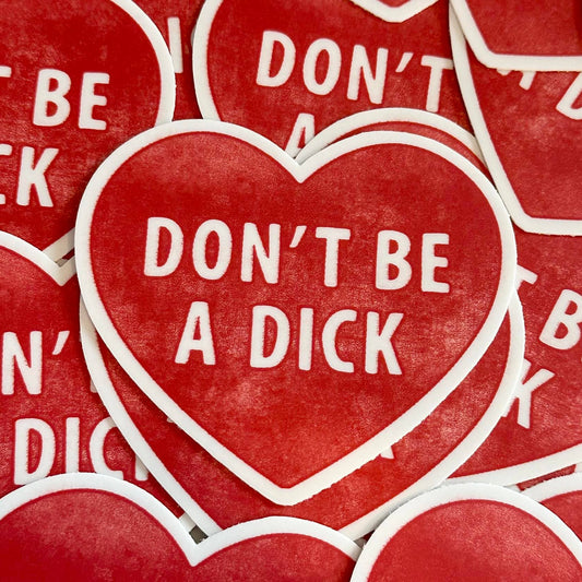 Red heart-shaped stickers with 'DON'T BE A DICK' text on a red background