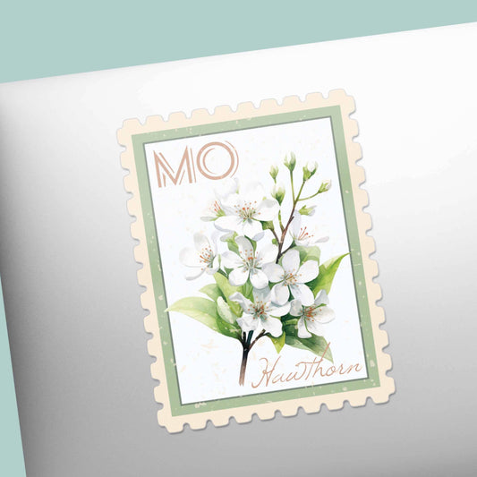 Decorative stamp with white flowers and green leaves on a laptop