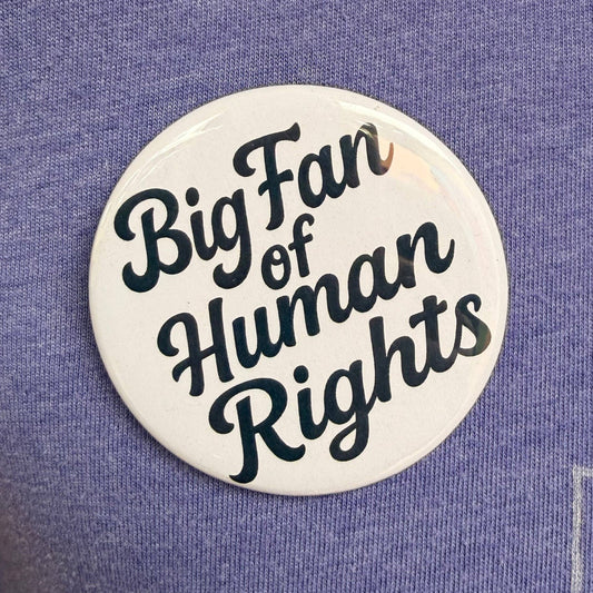 Round button with 'Big Fan of Human Rights' text on a purple background