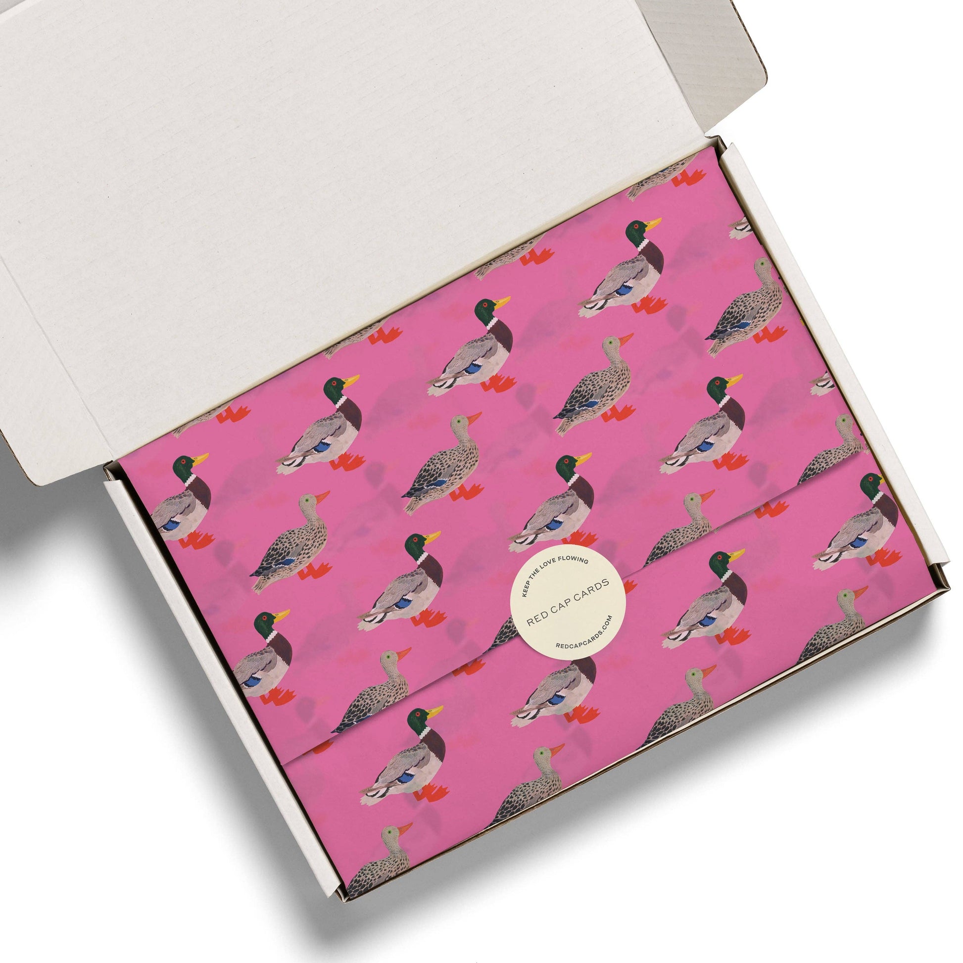 Pink box with duck pattern on a white background